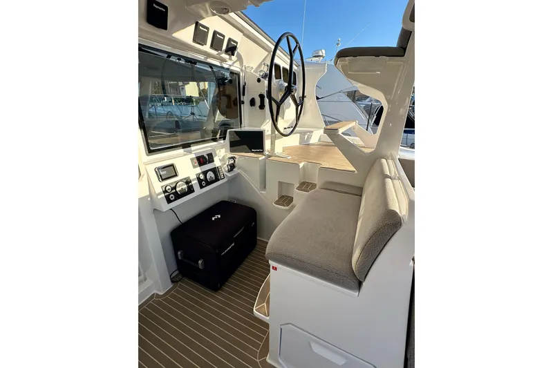 Slide: The Image of Interior of 2022 Balance 526 boat with steering wheel and navigation equipment. - 17