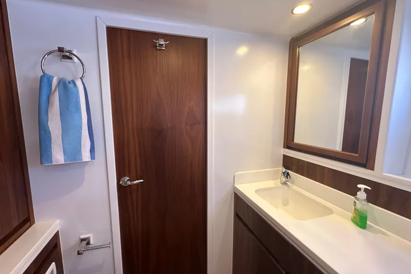 Slide: The Image of Modern bathroom interior with wooden accents, featuring a mirror, sink, and blue towel. Balance 526, 2022. - 20