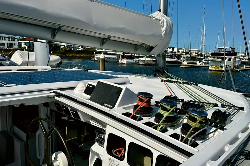 Slide: The Image of Sailing yacht Balance 526, 2022 model, featuring solar panels and advanced rigging in a marina. - 21