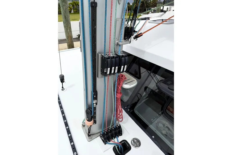 Slide: The Image of Sailboat rigging on a 2022 Balance 526, featuring ropes and pulleys on deck. - 24
