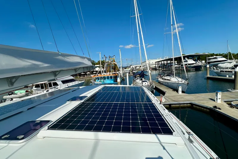 Slide: The Image of Sailboat with solar panels docked at marina, Balance 526 model, 2022. - 26