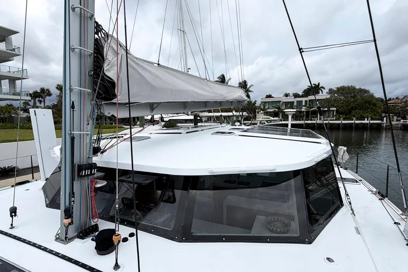 Slide: The Image of Sailing yacht Balance 526, 2022 model, docked near waterfront homes. - 29