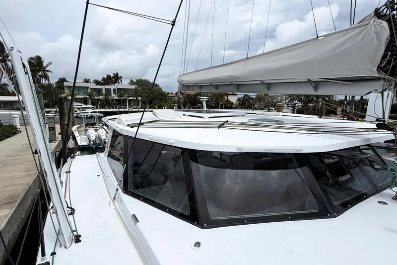 Slide: The Image of Modern Balance 526 catamaran docked, showcasing sleek design and spacious deck, 2022 model. - 37