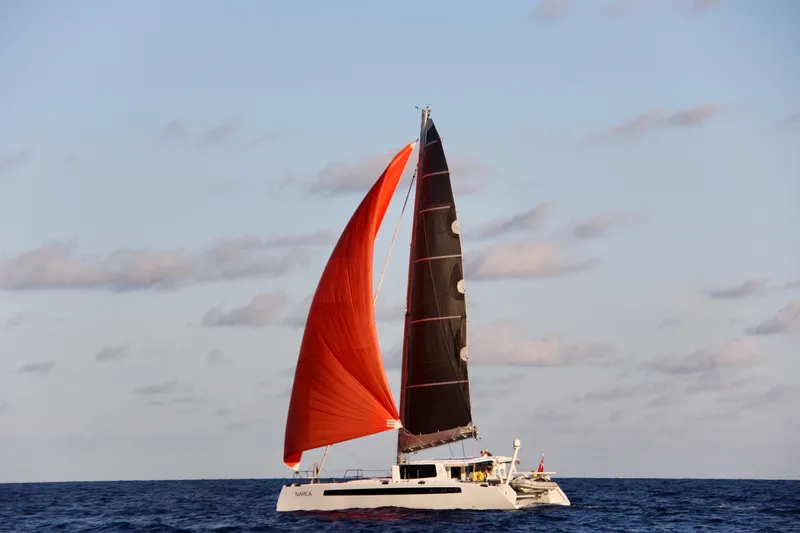 Slide: The Image of Sailing catamaran Balance 526 with vibrant sails on open sea, 2022 model. - 4