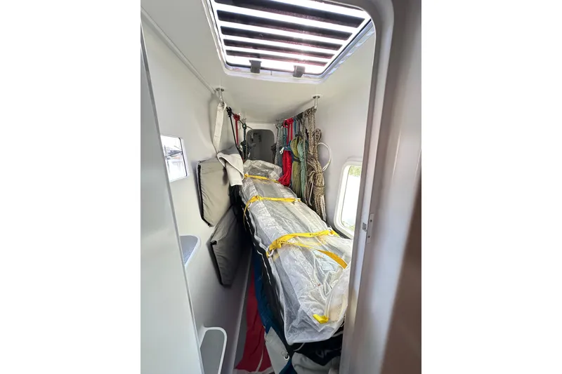 Slide: The Image of Interior of a 2022 Balance 526 sailboat with stored equipment and ropes. - 48