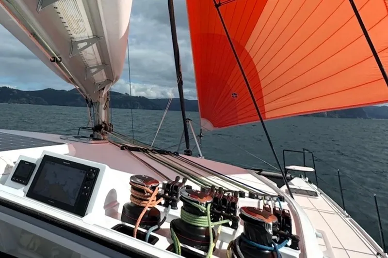 Slide: The Image of Sailing on a 2022 Balance 526 yacht with vibrant orange sails and advanced navigation equipment. - 50