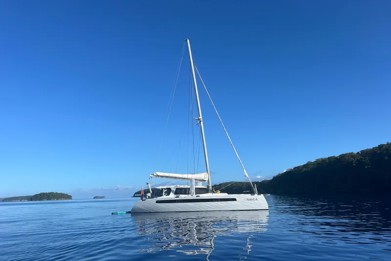 Slide: The Image of Sailing catamaran Balance 526, 2022 model, anchored in calm blue waters under clear sky. - 52