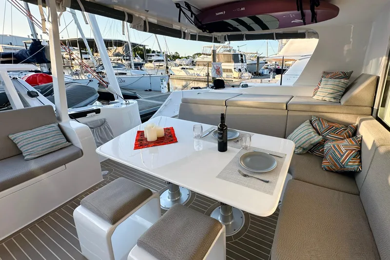 Slide: The Image of Luxurious 2022 Balance 526 yacht interior with elegant dining setup and marina view. - 7