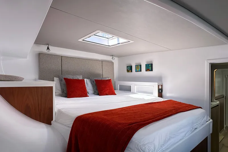 Slide: The Image of Luxurious bedroom in 2022 Balance 526 yacht with skylight and vibrant red accents. - 9
