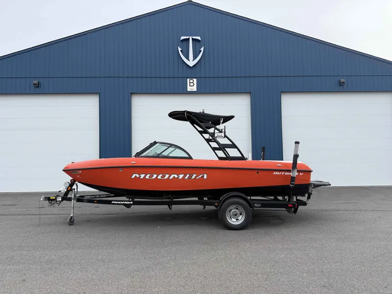 The Image of 2015 Moomba Outback V boat in front of blue garage. - 1