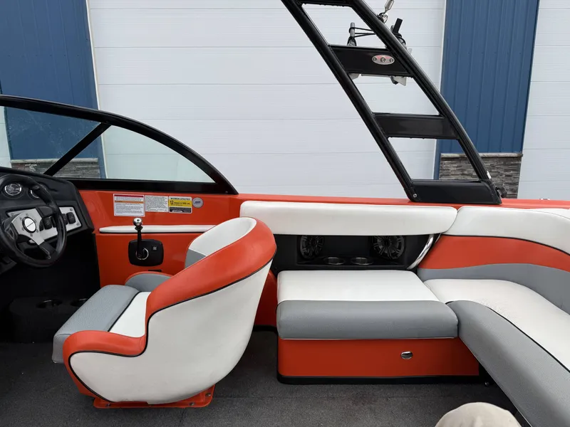 Slide: The Image of Interior of a 2015 Moomba Outback V boat, orange and white seating. - 12