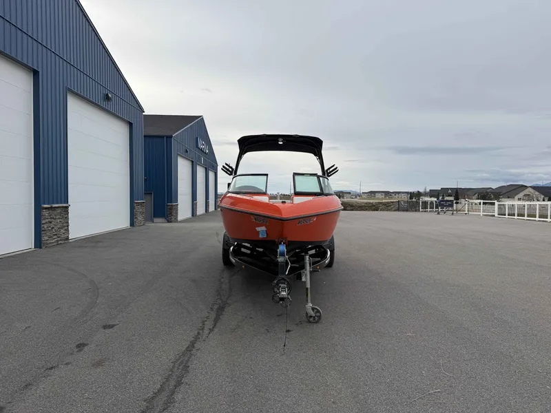 Slide: The Image of 2015 Moomba Outback V boat in front of blue warehouse. - 3