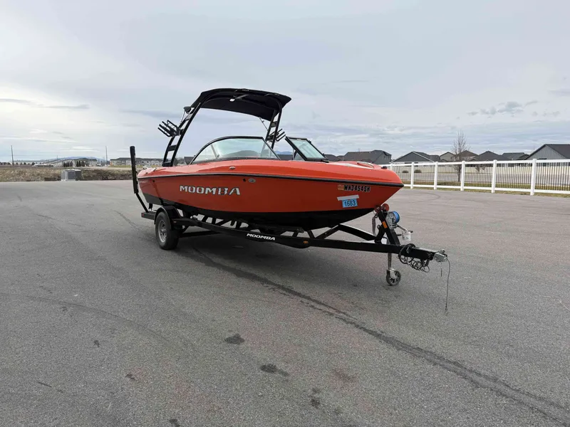 Slide: The Image of 2015 Moomba Outback V boat on trailer, parking lot. - 4