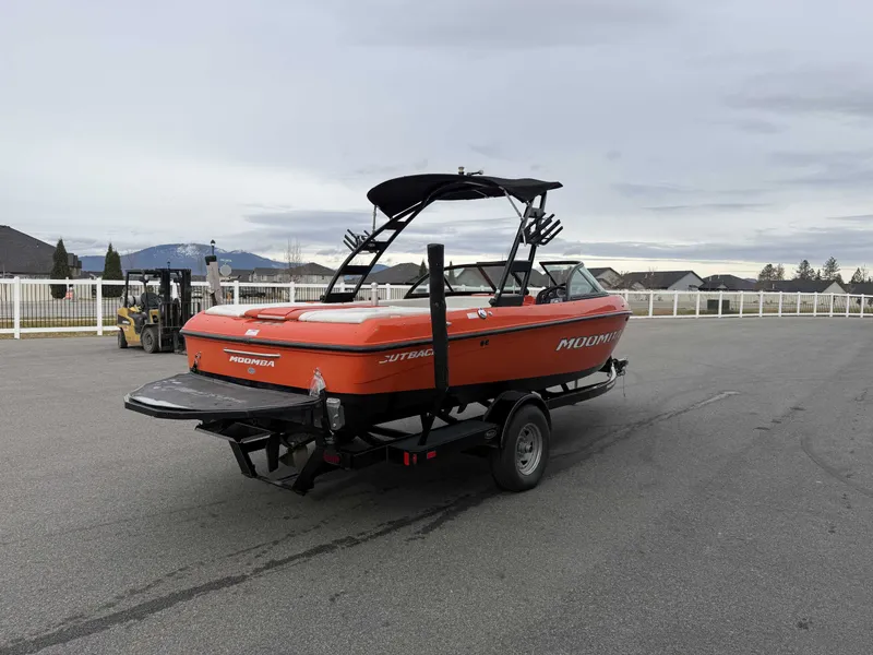 Slide: The Image of 2015 Moomba Outback V boat parked on trailer outdoors. - 5