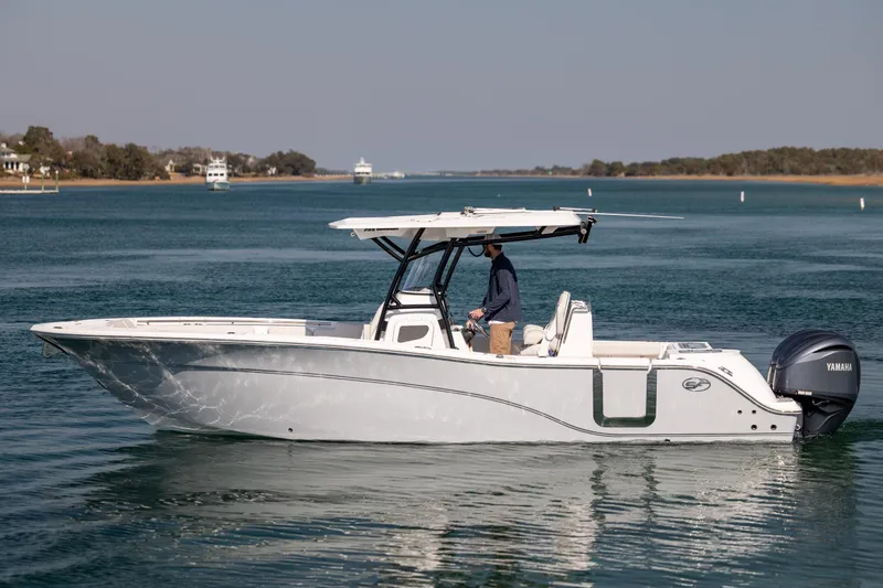 The Image of 2023 Sea Fox 288 Commander boat cruising on calm waters with a person at the helm. - 1