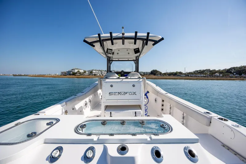Slide: The Image of 2023 Sea Fox 288 Commander boat on calm water, showcasing spacious deck and modern design. - 12