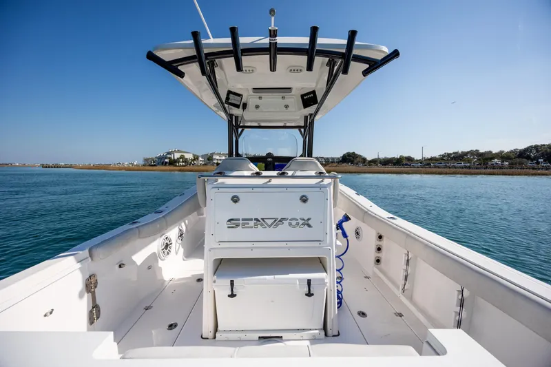 Slide: The Image of 2023 Sea Fox 288 Commander boat on calm water, showcasing spacious deck and modern design. - 13