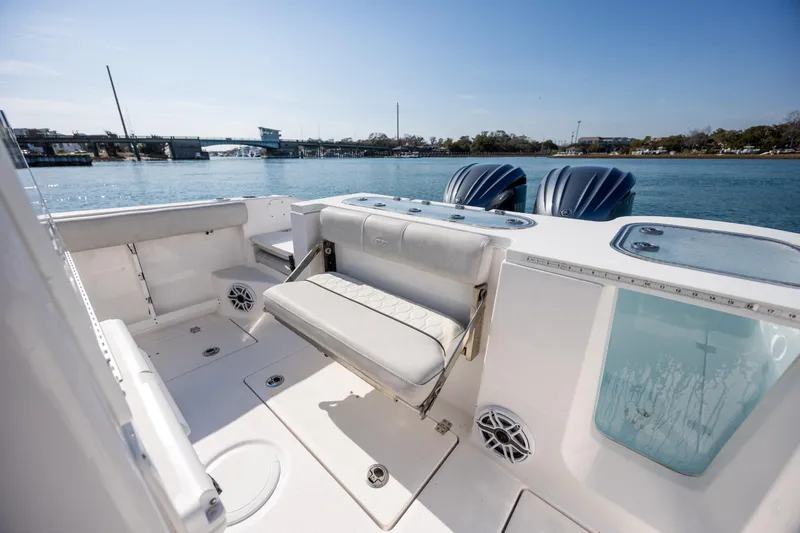 Slide: The Image of 2023 Sea Fox 288 Commander boat interior with seating and dual engines on a sunny day. - 16