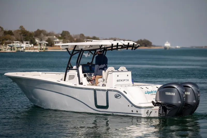 Slide: The Image of 2023 Sea Fox 288 Commander boat with dual Yamaha engines on calm water. - 2