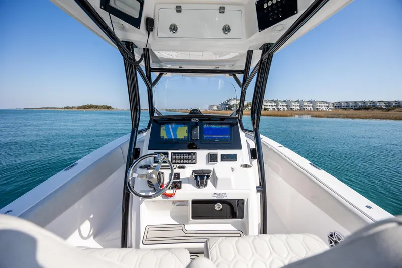Slide: The Image of 2023 Sea Fox 288 Commander boat dashboard with dual screens on calm water. - 20