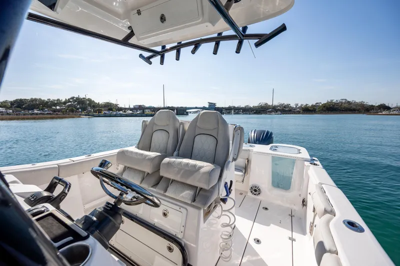 Slide: The Image of 2023 Sea Fox 288 Commander boat interior with dual seats on a sunny day. - 24