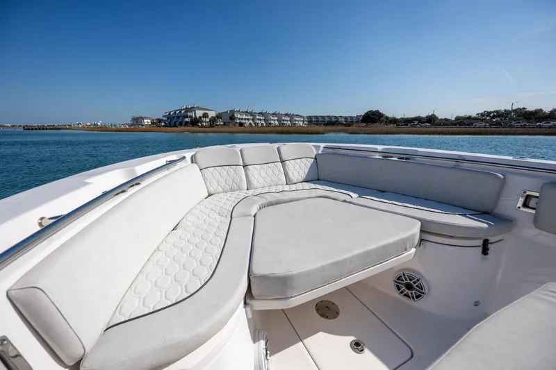 Slide: The Image of 2023 Sea Fox 288 Commander boat interior with cushioned seating, on a sunny day. - 26