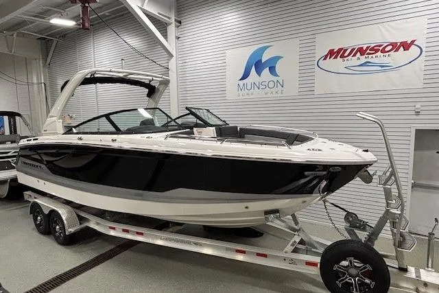 The Image of 2026 Chaparral SSX 8 boat on trailer in showroom, Munson Ski & Marine signage. - 0