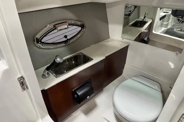 Slide: The Image of 2026 Chaparral SSX 8 boat interior with sink, toilet, and mirror. - 25