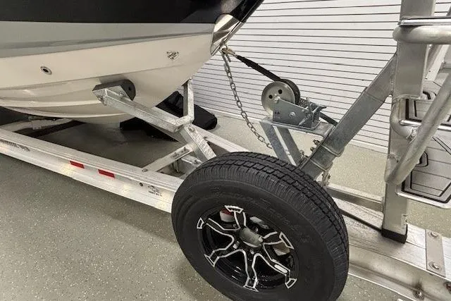 Slide: The Image of 2026 Chaparral SSX 8 boat on trailer with black wheel and winch system. - 27