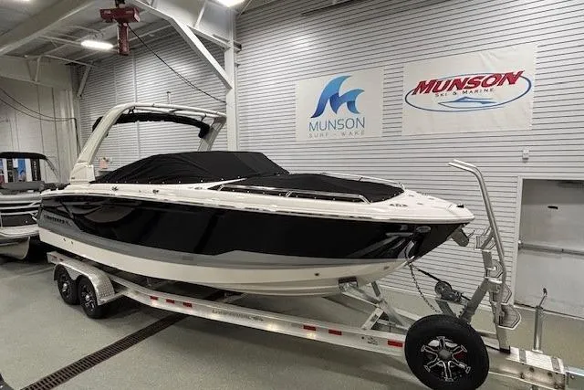 Slide: The Image of 2026 Chaparral SSX 8 boat on trailer in showroom with Munson signage. - 3