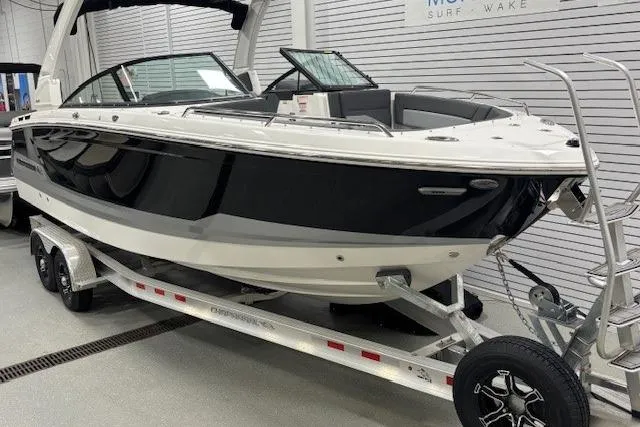 Slide: The Image of 2026 Chaparral SSX 8 boat on trailer in showroom setting. - 31