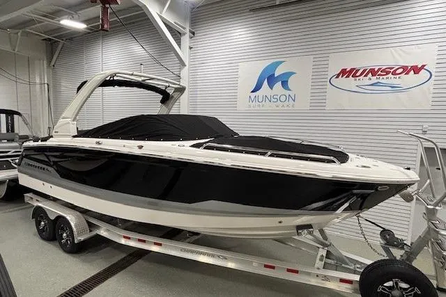 Slide: The Image of 2026 Chaparral SSX 8 boat on trailer in showroom, Munson Marine signage visible. - 33