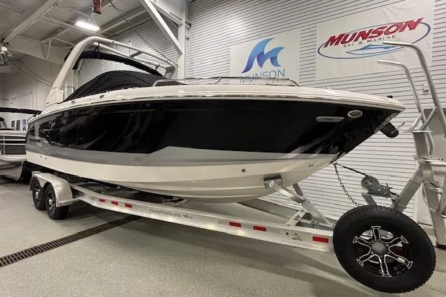 Slide: The Image of 2026 Chaparral SSX 8 boat on trailer in showroom, Munson Marine signage visible. - 34