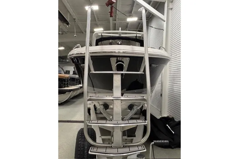Slide: The Image of 2026 Chaparral SSX 8 boat front view in showroom with ladder. - 37