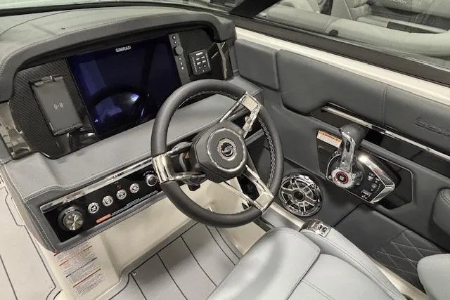 Slide: The Image of 2026 Chaparral SSX 8 boat cockpit with modern steering wheel and control panel. - 4