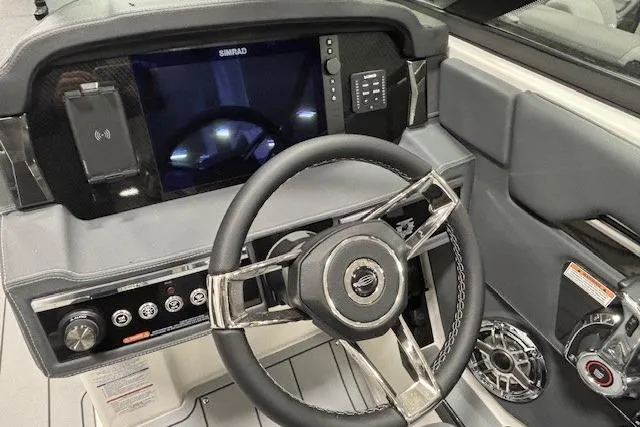 Slide: The Image of 2026 Chaparral SSX 8 boat dashboard with steering wheel and control panel. - 6
