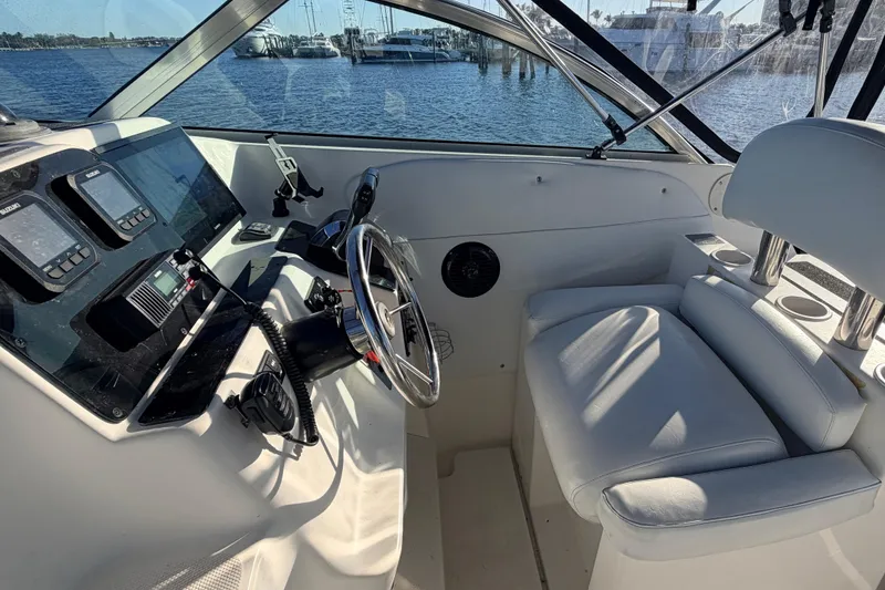 Slide: The Image of 2000 Wellcraft 270 Coastal O/B boat cockpit with steering wheel and navigation instruments. - 12