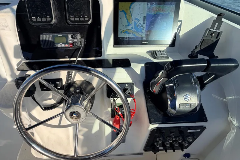 Slide: The Image of Control panel of 2000 Wellcraft 270 Coastal O/B with steering wheel and navigation equipment. - 13