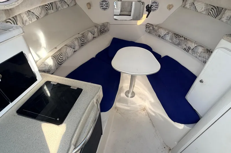 Slide: The Image of Interior of 2000 Wellcraft 270 Coastal O/B boat with seating and table. - 17