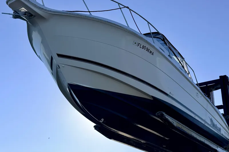 Slide: The Image of 2000 Wellcraft 270 Coastal O/B boat lifted against clear blue sky. - 28