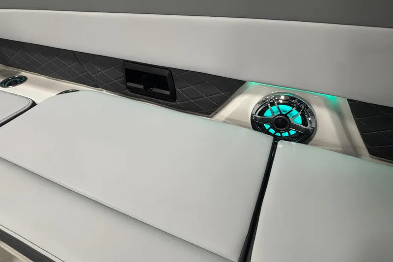 Slide: The Image of 2026 Chaparral SSX 30 boat interior with illuminated speaker and quilted upholstery. - 36