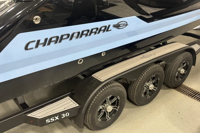 Slide: The Image of 2026 Chaparral SSX 30 boat on a trailer, showcasing sleek design and branding. - 4