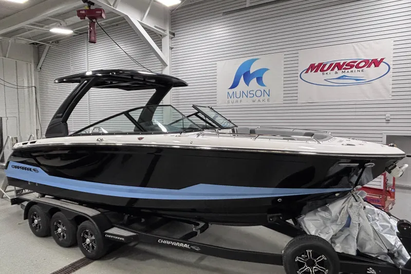 Slide: The Image of 2026 Chaparral SSX 30 boat in showroom, Munson Surf & Wake signage visible. - 12