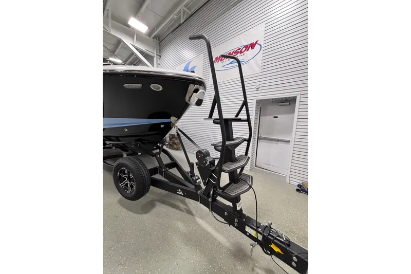 Slide: The Image of 2026 Chaparral SSX 30 boat on trailer with ladder in showroom. - 16