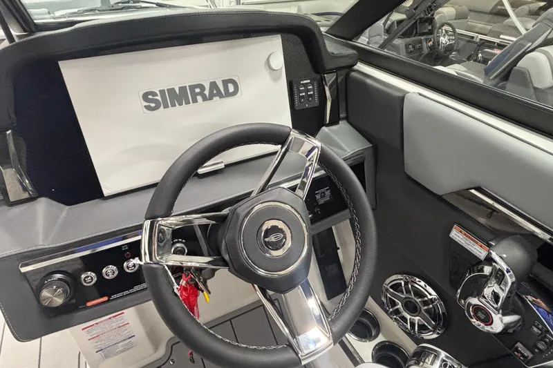 Slide: The Image of 2026 Chaparral SSX 30 boat dashboard with Simrad display and steering wheel. - 23