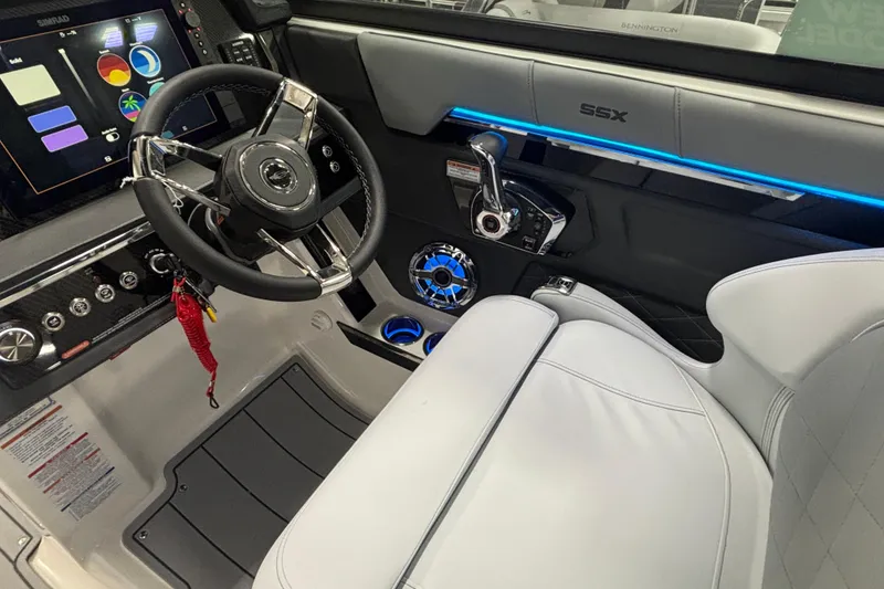 Slide: The Image of 2026 Chaparral SSX 30 boat cockpit with modern steering, controls, and illuminated dashboard. - 35