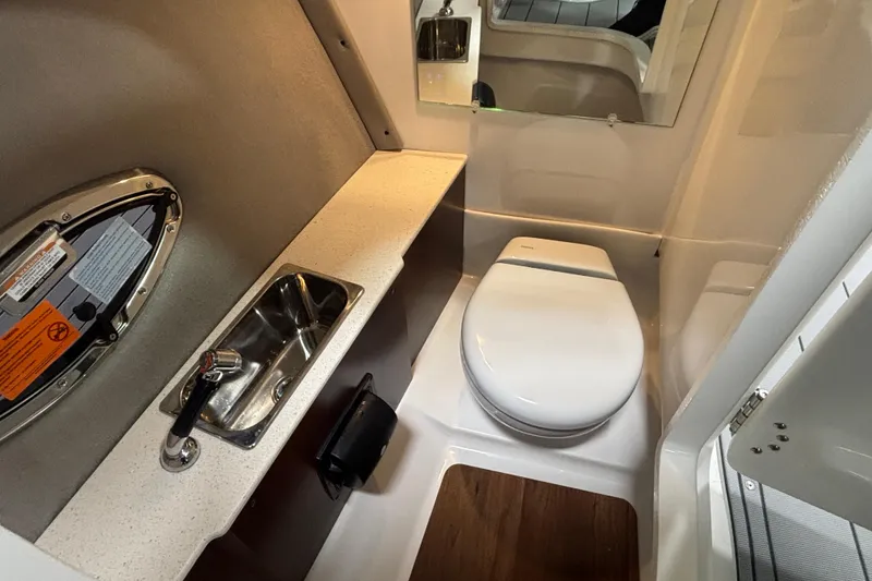 Slide: The Image of 2026 Chaparral SSX 30 boat bathroom with sink, toilet, and mirror. - 42