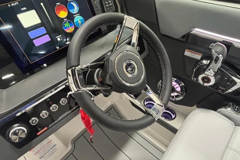 Slide: The Image of 2026 Chaparral SSX 30 boat dashboard with modern steering wheel and digital controls. - 43