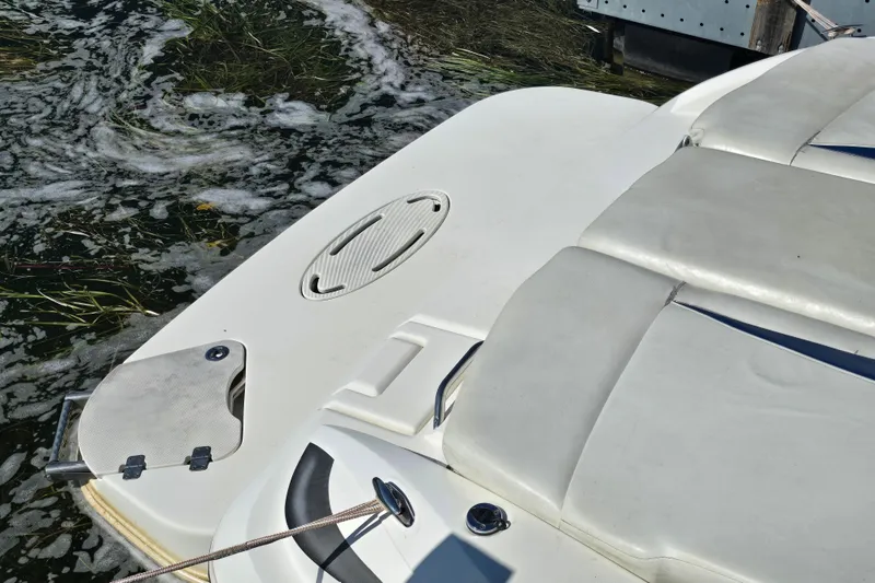 Slide: The Image of 2008 Larson Senza 186 boat with white seating and swim platform near water. - 10