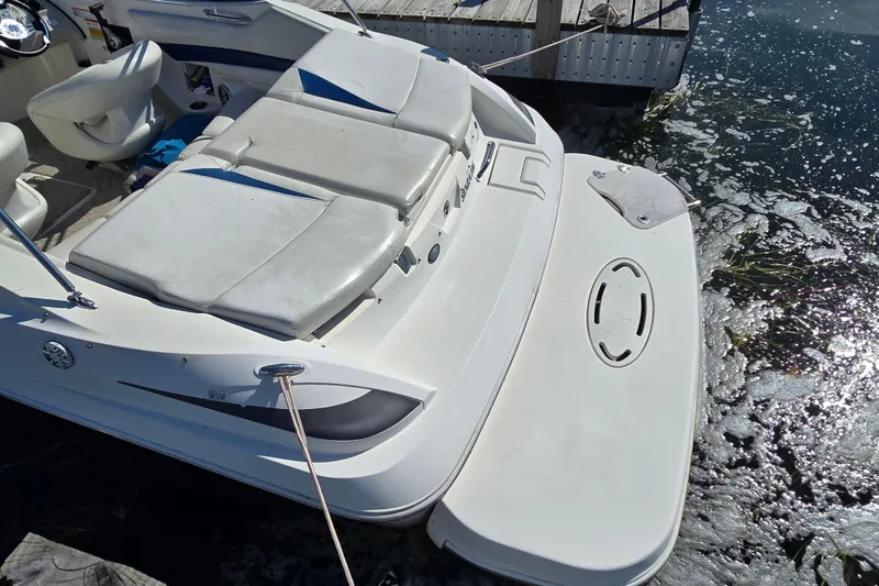 Slide: The Image of 2008 Larson Senza 186 boat docked, featuring spacious seating and swim platform. - 13